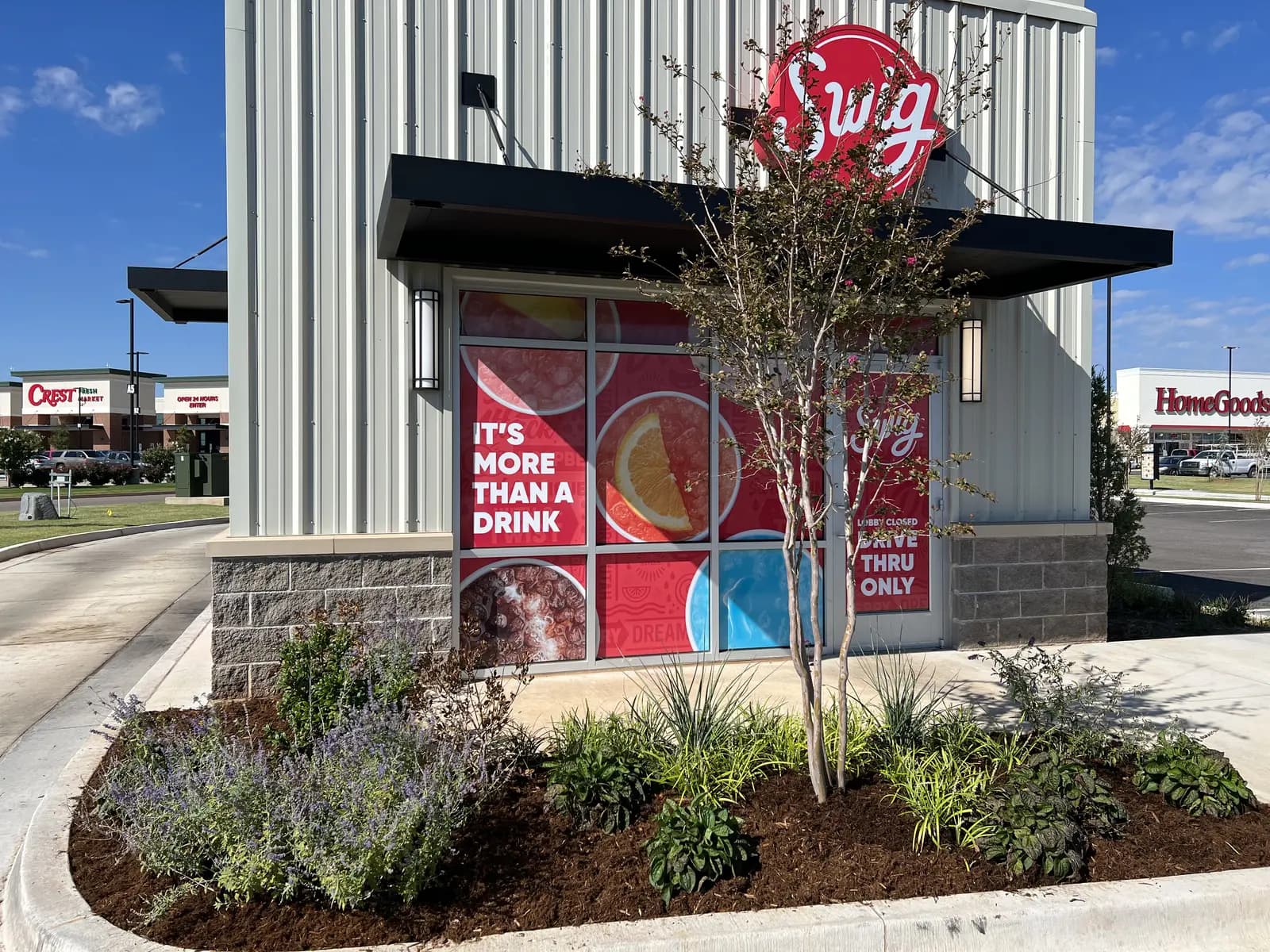 Newly planted and mulched commercial landscape bed along the Swig storefront