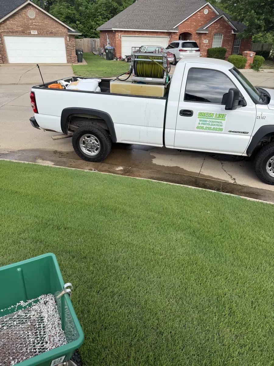 Greenline treatment truck and equipment at a residential lawn