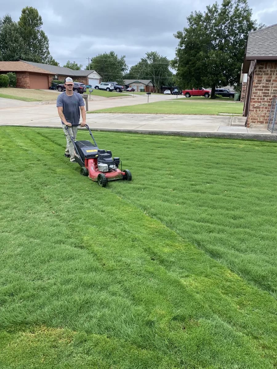Greenline crew member making a clean mowing pass through residential turf
