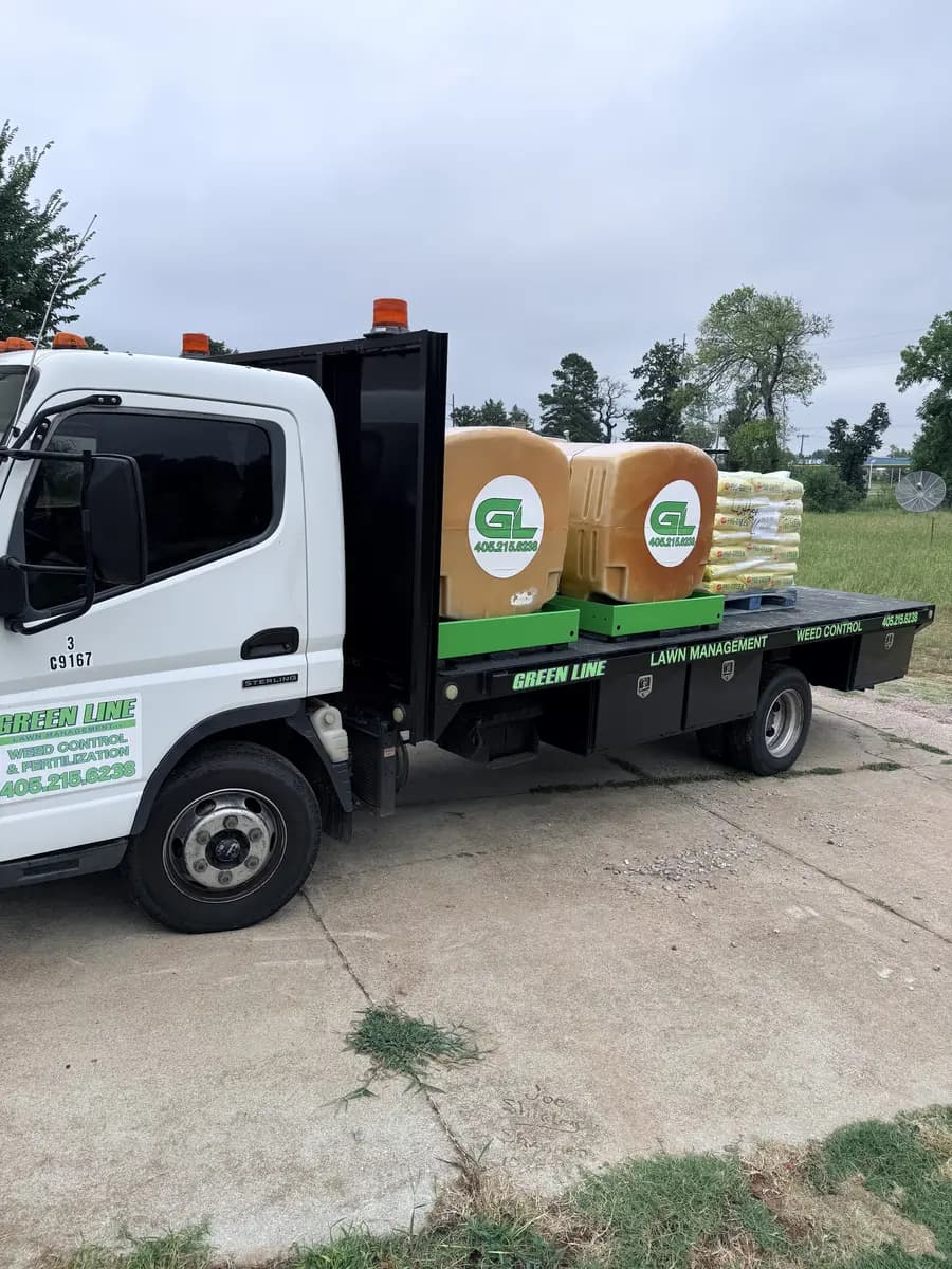 Greenline weed-control and fertilization truck carrying liquid tanks and bagged lawn-care material