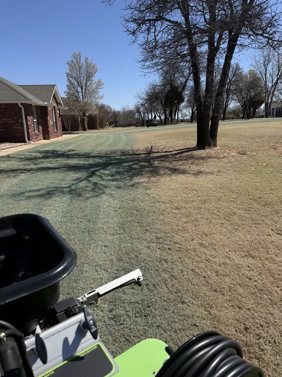 Greenline technician applying an even seasonal turf treatment